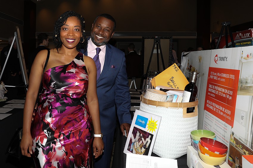 Mylling Chery and Dr. Jerry Chery peruse the hundreds of gift auction items available.