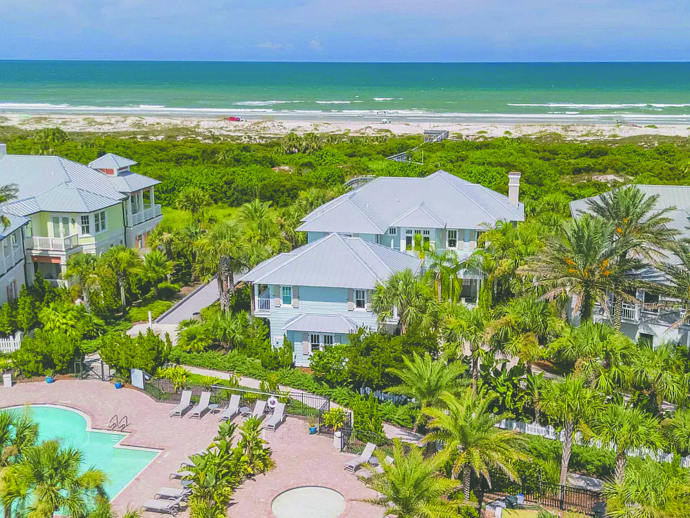 Oceanfront two-story home features five bedrooms, four full and one half-bathrooms, office, elevator, porches, pool and guest suite above detached garage.