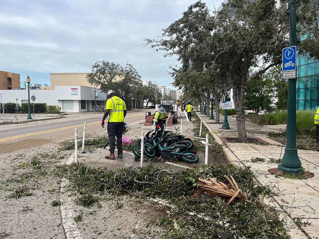 Crews work to clear debris from Main Street in downtown Sarasota.