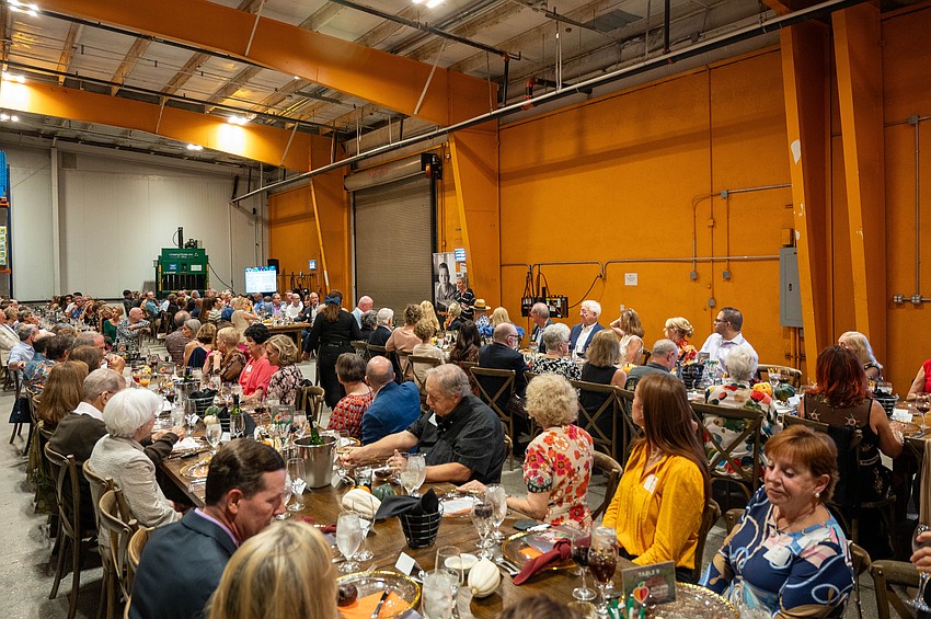 Guests enjoy dinner together to raise funds for All Faiths Food Bank.