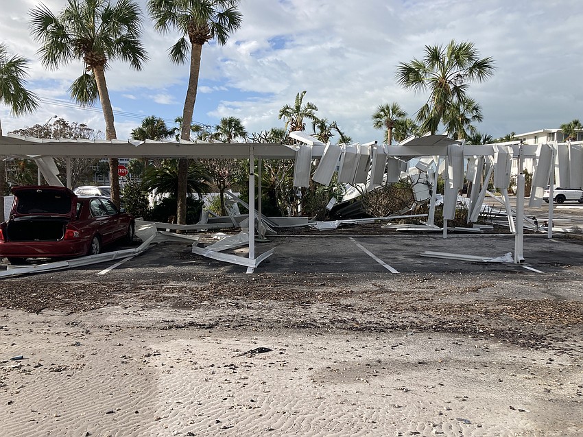 Pieces of carport dangle like piano keys at Sarasota Harbor West.