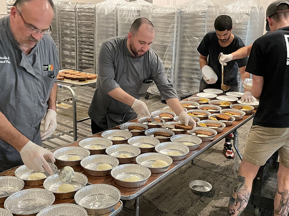 Jamil Pineda, Carlos Avella, Damian Richardson and Ryan Alexander prep 500 hot meals for North Port first responders.