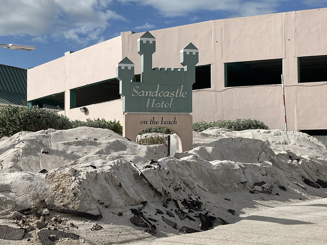 The sand pushed ashore during Hurricane Helene gives credence to the Sandcastle Hotel.