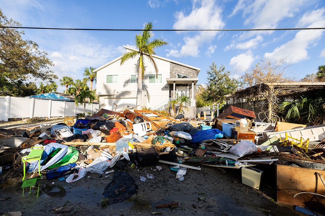 Discarded belongings flooded from Hurricane Helene were scattered by Hurricane Milton's winds on Siesta Key, where the storm made landfall.