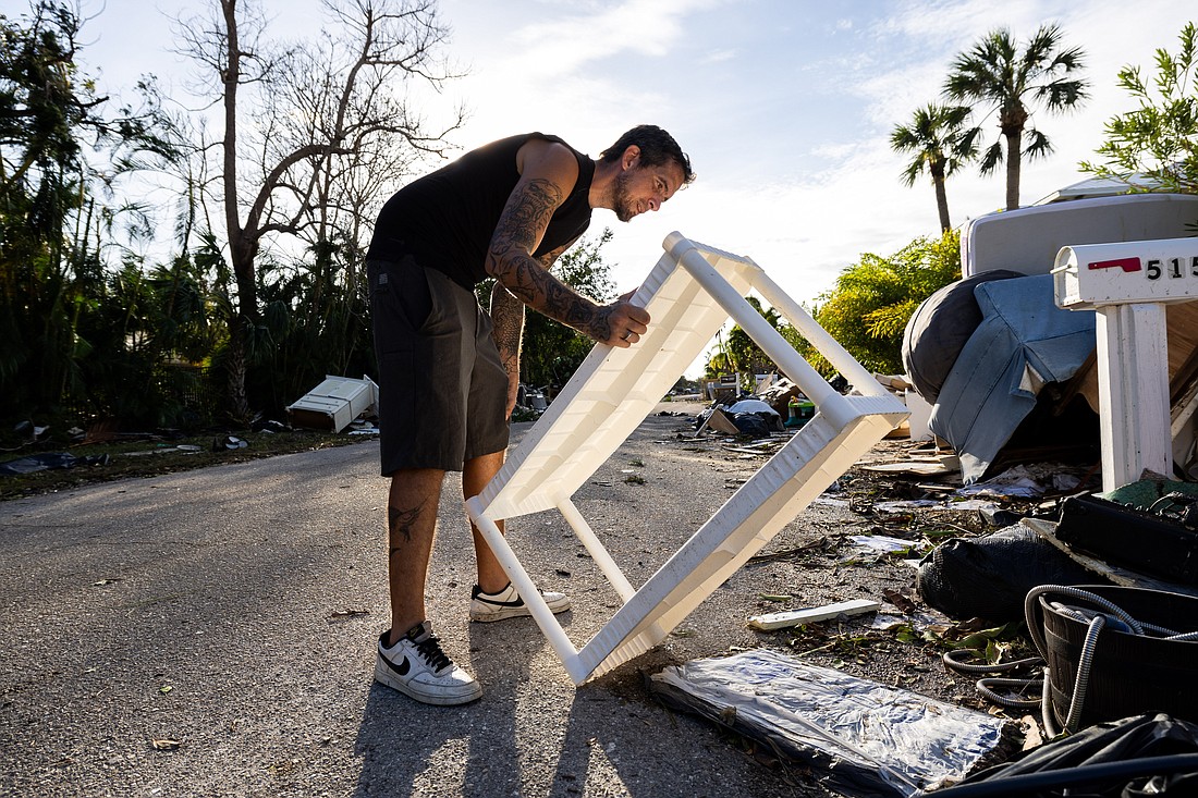 Kyle Kolaski sorts through a debris pile on Siesta Key the day after Hurricane Milton made landfall there on Oct. 9.