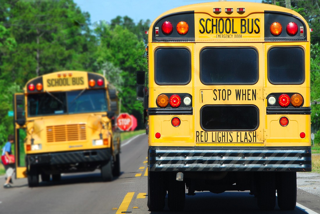 school bus on rural road picking up children