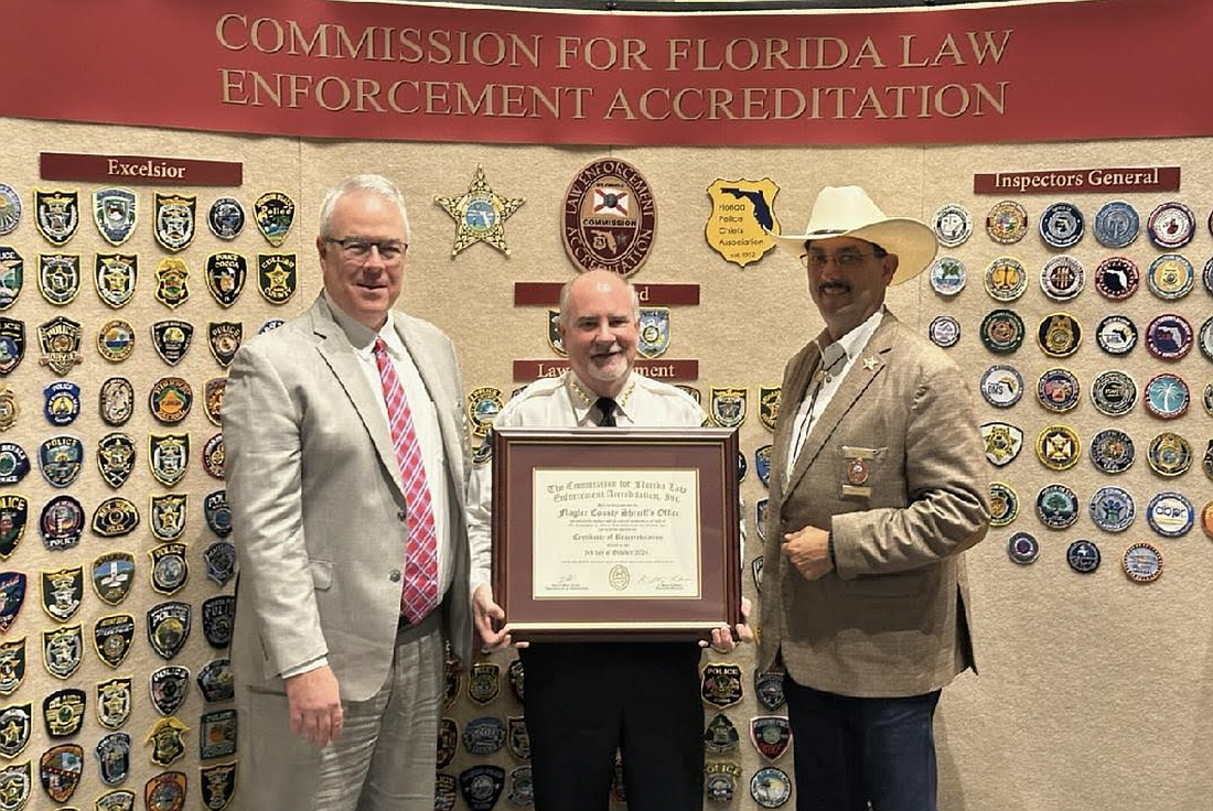 Florida Accreditation Office Executive Director Stacy Lehman (left), Board of Commissioners Chair and Marion County Sheriff Billy Woods (right) award Sheriff Rick Staly the Certificate of Reaccreditation. Courtesy photo