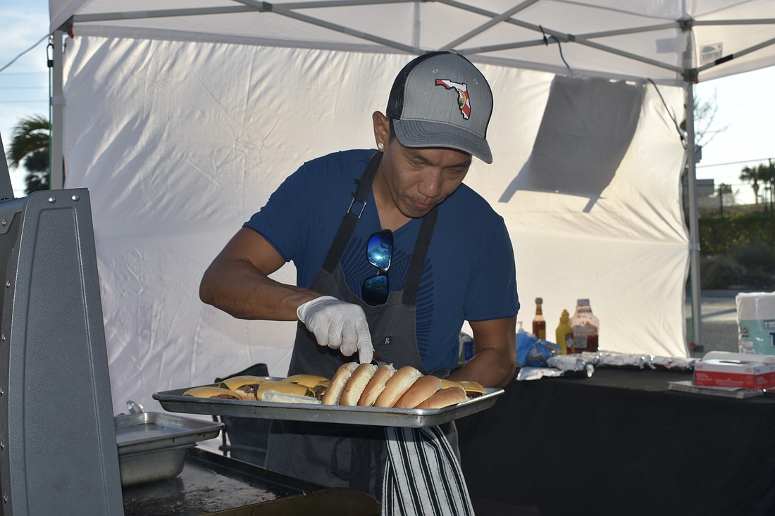 Bruno Wu serves hamburgers.