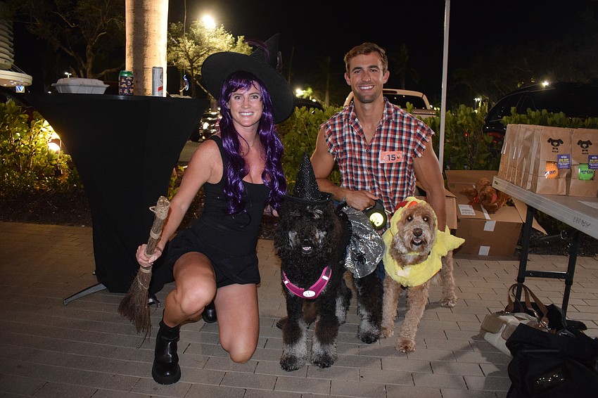 Bradenton's Eryn Skage dresses as a witch to match their dog Rye, while Scott Skage dresses as a farmer to go with their dog Whiskey, who is dressed as a chicken. Whiskey loves chasing chickens while the witch fits Rye's personality, Scott Skage says.