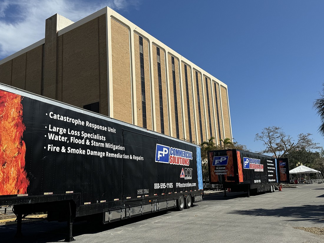 Property restoration and damage response teams are set up outside the Sarasota County Administration Center on Ringling Boulevard on Oct. 17.