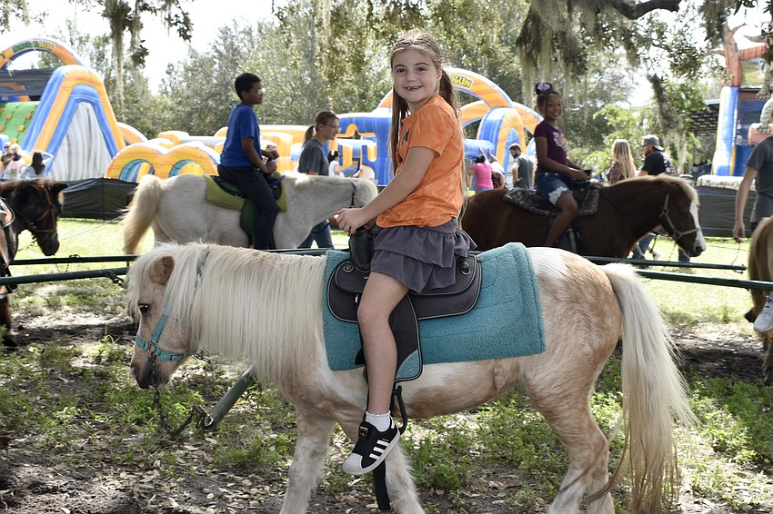 Vivienne Szlezak, 8, goes for a pony ride.