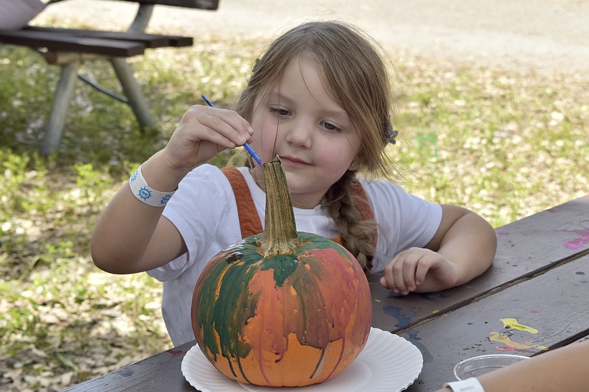 Kennedy Cavender, 4, decorates a pumpkin.