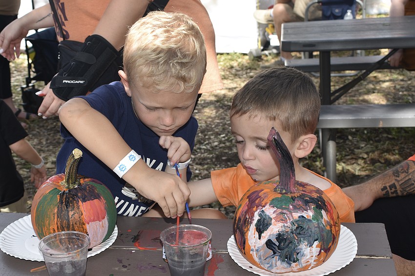 Dominic Chaviano, 6 and Giovanni Martinez, 4, paint their pumpkins.