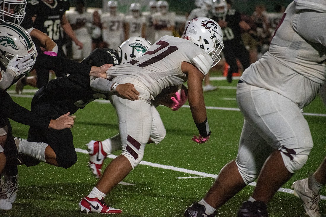 Braden River's Jayden Moore (21) fights through the Lakewood Ranch front seven. It can cost about $164 for a football jersey and pants. A football helmet can range from $180 to $500.