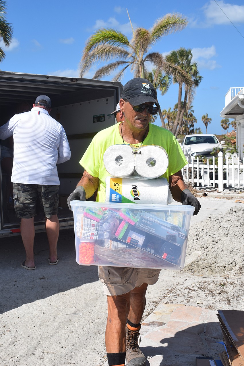 Tom Lopes bringing in supplies collected by students from Milton High School in Georgia.