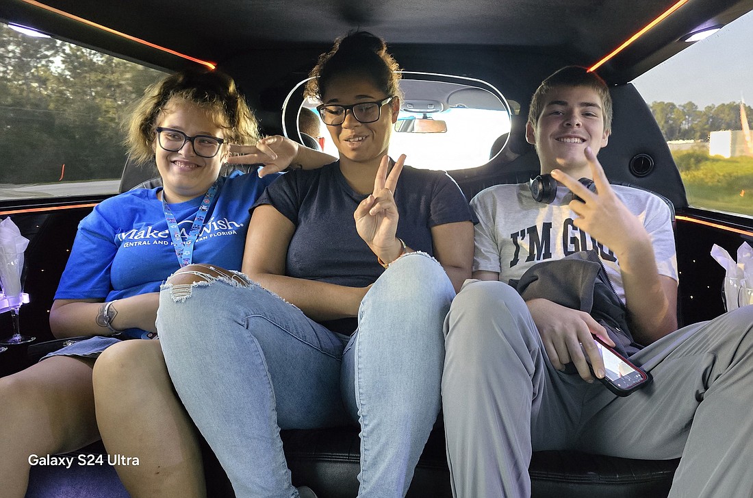 Make-A-Wish recipient Haven Walker (left) with her sister, Keisha, and brother Kenton riding in the limo to the Florida Mall in Orlando for Haven's shopping spree. Courtesy photo