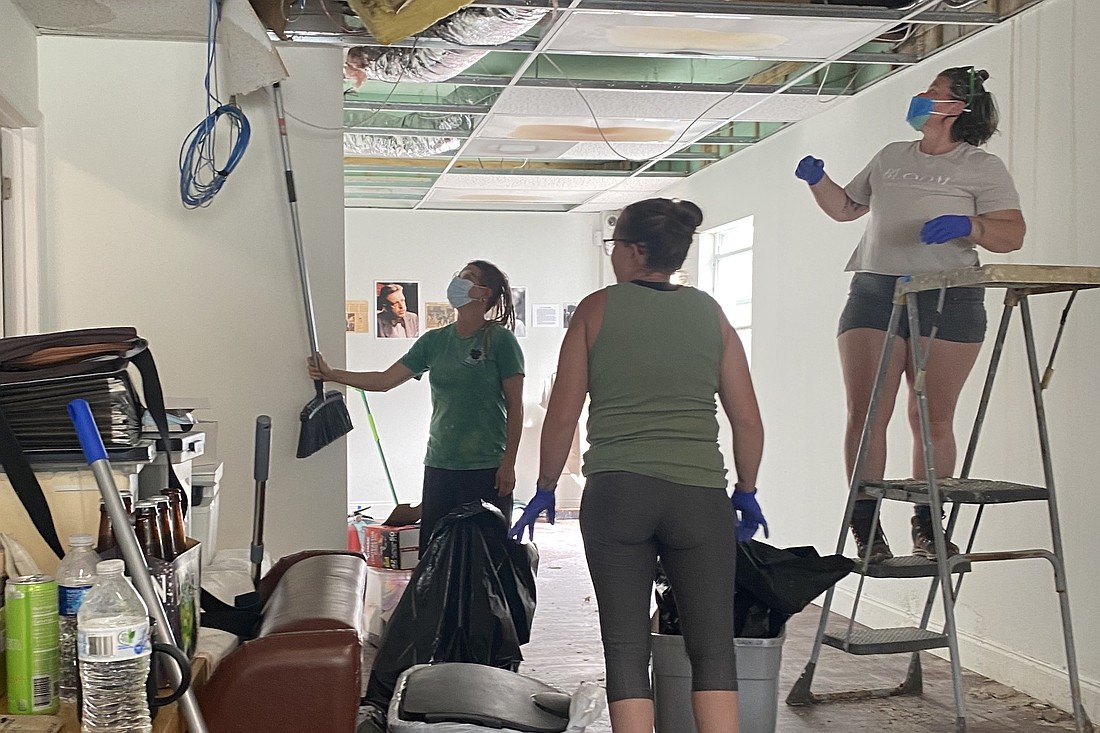 A crew helps clean up the impacts of Hurricane Milton in the LGBTQ+ center.