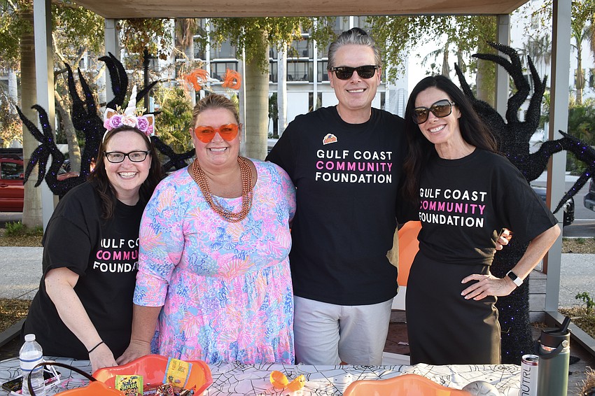 Rachel Denton; Tami Lanham; her husband Philip Lanham, who is president and CEO of Gulf Coast Community Foundation and Emily Joslin were among those who staffed the foundation's trick-or-treat stations.