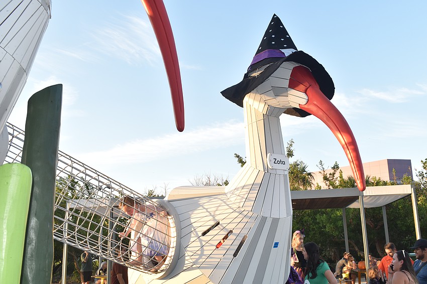 Charlotte McKinniss, 5, plays on the Ibis Playground, where the two ibises, Sara and Zota, wore witches' hats.