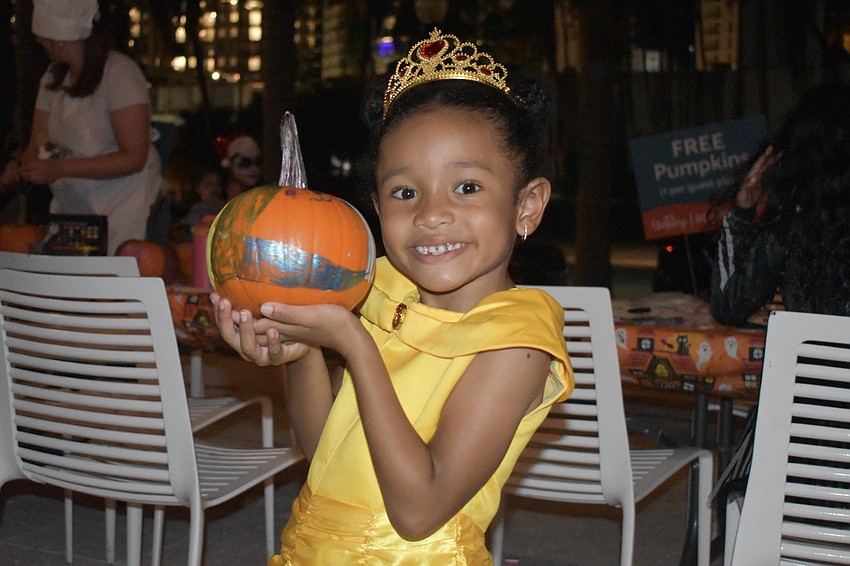 Ariel Gibbs, 6, holds her decorated pumpkin.