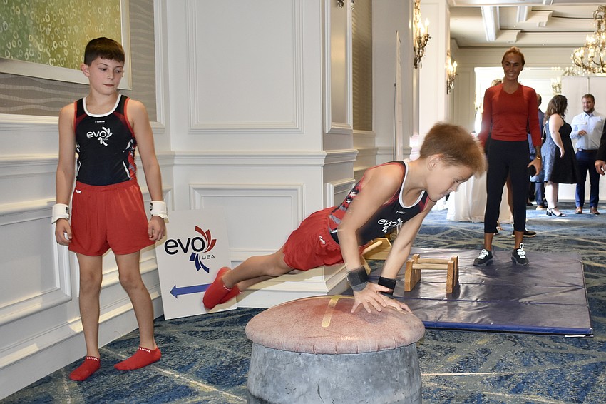 Blake Kilroy, 11 and Luca Leykin, 9 of EVO Gymnastics offer a demonstration of their skills in the reception area.