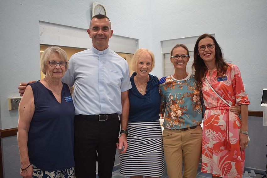 Gayle Sobieck, the Rev. Robert Dziedziak, Sue DiNatale, Susan Udermann, Maureen Watterson at the St. Mary Star of the Sea potluck.