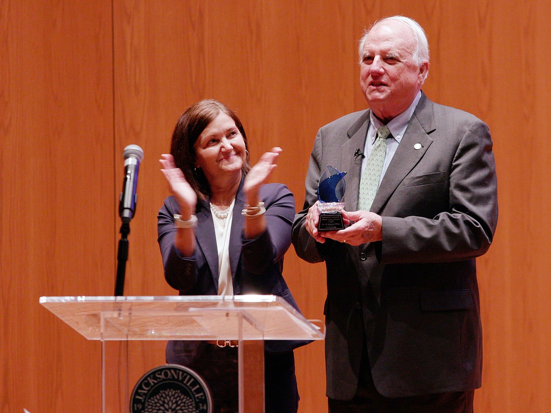 Jacksonville University interim Provost and Senior Vice President Sherri Jackson presented the 2024 Pioneer Award to Quint White, founding executive director of the Marine Science Research Institute and professor emeritus of biology and marine science at JU, at a ceremony Oct. 24 in Terry Concert Hall.