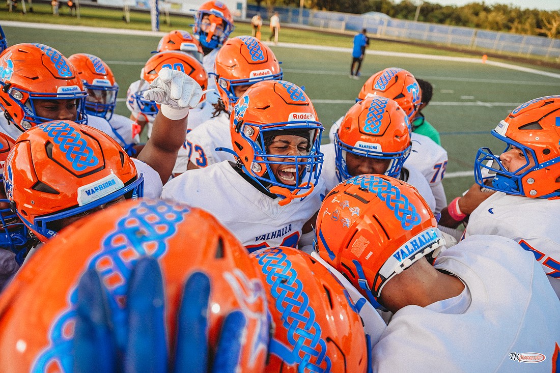 West Orange football players gather on Raymond Screws Field to get hyped before kickoff.