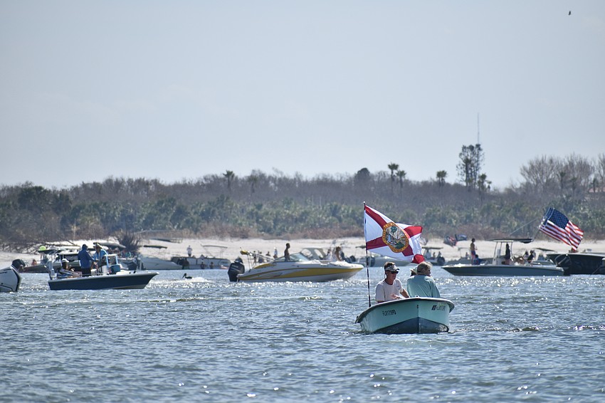 Boats gather beside the opening of Midnight Pass.