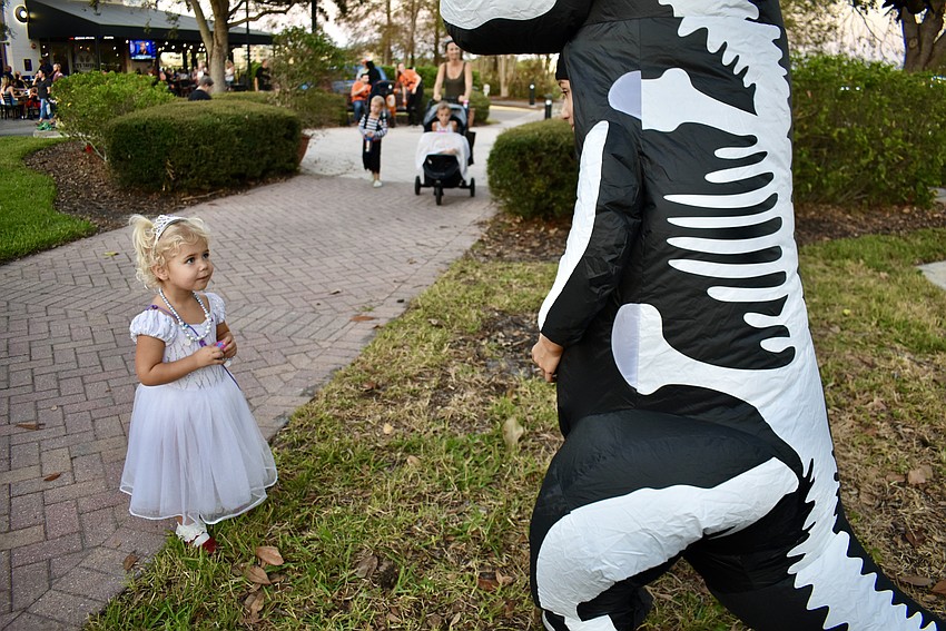 Savanna's Caroline Caldwell, 2, can't take her eyes off the inflatable dinosaur skeleton.