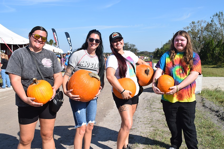 Ruskin's Jesika Peterman, Elizabeth Sacia, Aeriel Sacaia and Rachel Peterman pick out the largest pumpkins so they can have as many seeds as possible.
