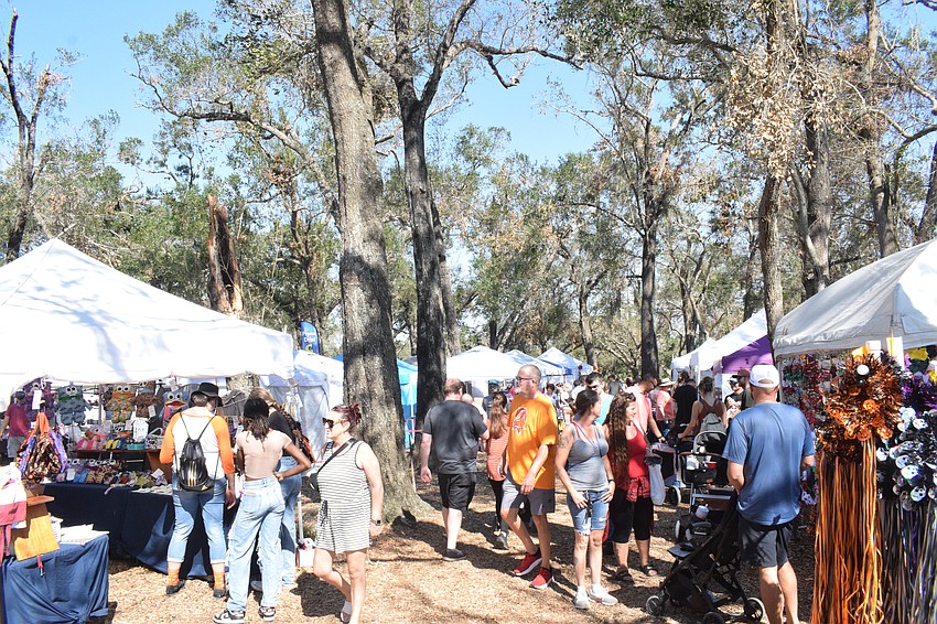 Hunsader Farms Pumpkin Festival attendees make their way through the craft vendor area.