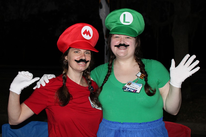 Sarasota Memorial's Angela Duffy, a clinical lead in urgent care, and Sarah Cook, a nurse, work a booth at the Boo Run.