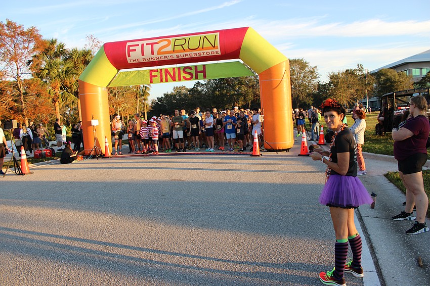 Former Boo Run Race Director Jen Tullio plays the role of photographer in the 2024 race.