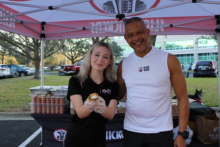 Slim Chickens Shift Manager Jenna Herbert and restaurant co-owner Tommy Elmahdi get ready to serve the runners. Slim Chickens was a major race sponsor.