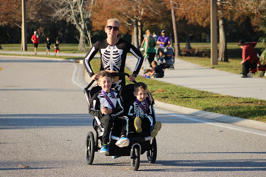 No bones about it, Sarasota's Kate Gerber gives her 6-year-old Graham and her 3-year-old Ben a fun ride in the Boo Run.