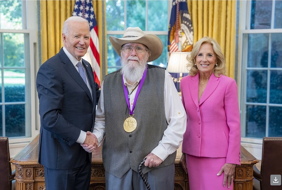 Venice photographer Clyde Butcher is flanked by President Joe Biden and First Lady Jill Biden after receiving the National Medal of Arts on Oct. 21.