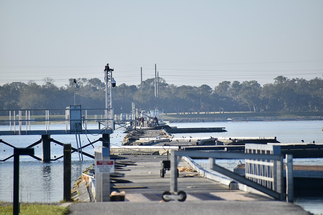 A crew works to repair the wave attenuator on Oct. 25.