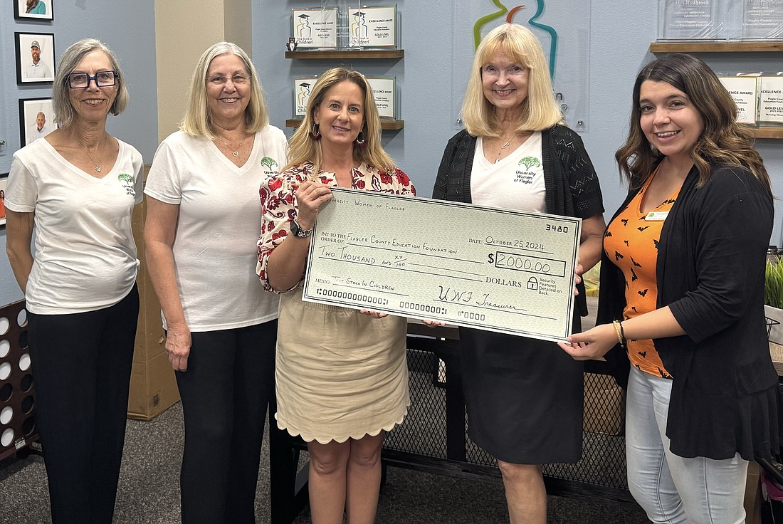 The University Women of Flagler's Trish LeNet, Linda Jaeger and Dr. Robin Hall present a check to the Flagler County Education Foundation's Teresa Rizzo (center) and Selina Hernandez (right). Courtesy photo