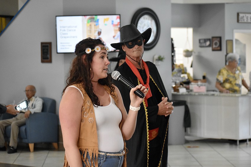 Gina Brockman of Golden Girl Solutions and Timothy Arbagy of Krazy Entertainment make an announcement.