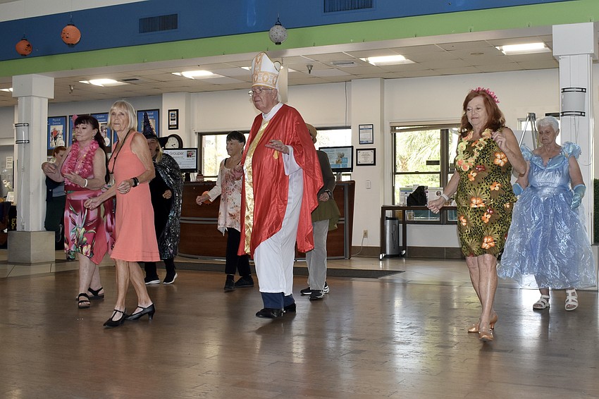 Attendees take to the dance floor, including Ron Longhurst (center).