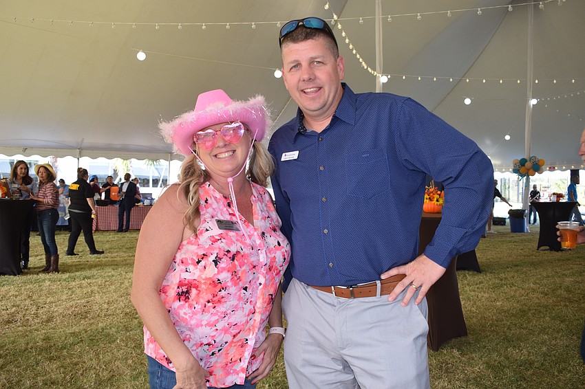 First Citizens Bank's Lisa Lawler and Greg Poznanski make an entrance at the Hob Nob. Lawler says she was going for a Barbie theme with her cowgirl hat and heart-shaped sunglasses.