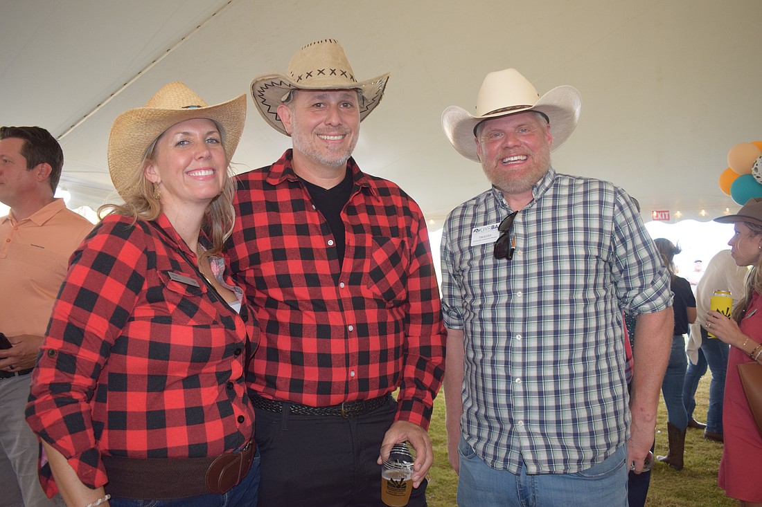 Jamie Kahns and Bob Kahns with Bank of America and Tim Estep, the manager for the Lakewood Ranch Business Alliance, get into the western theme for the alliance's Hob Nob.