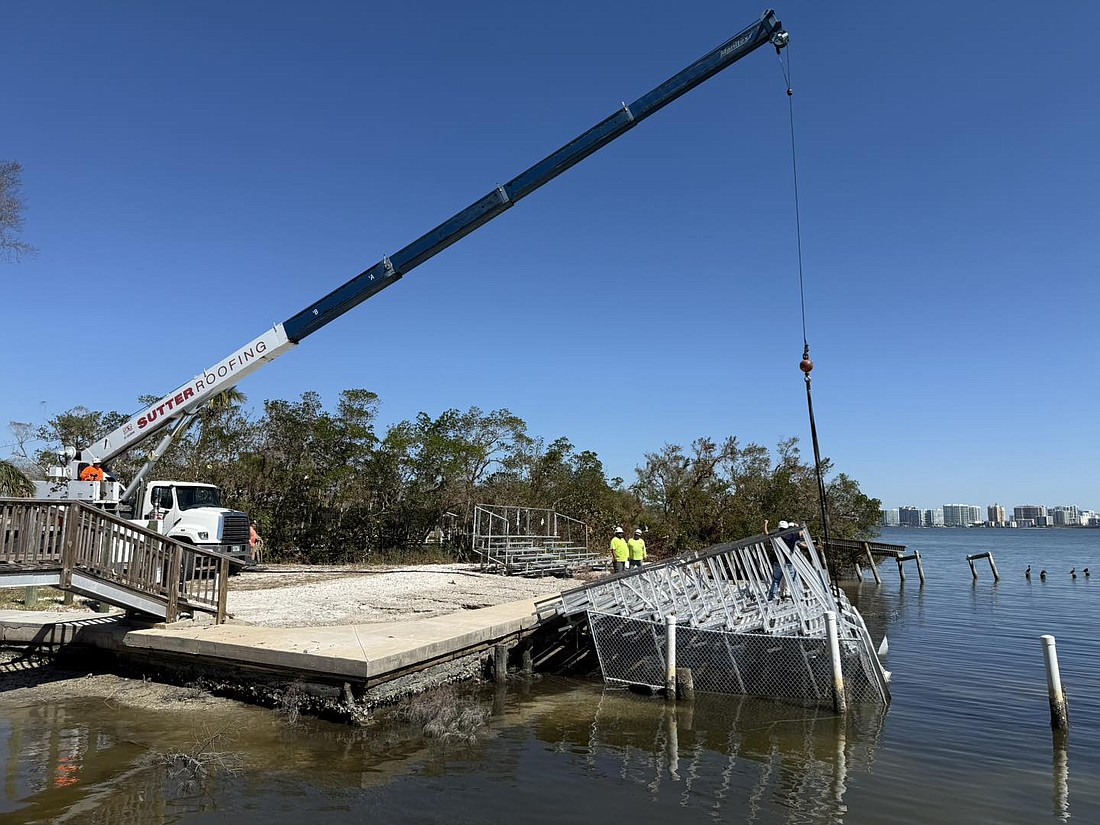 Sutter Roofing deployed its crane off City Island to pick up the Ski-A-Rees bleachers.