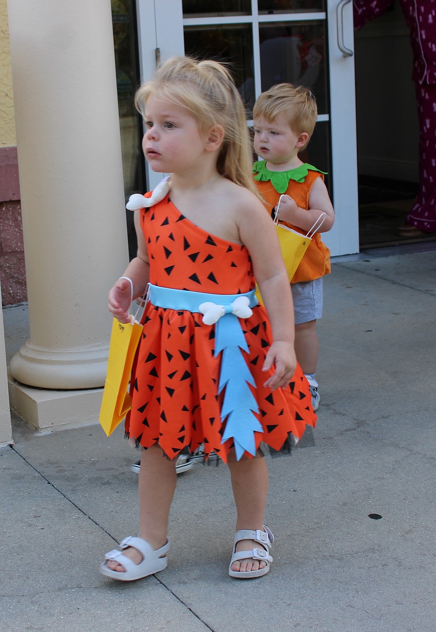 Teagan Biggs shows off her costume during the Kiddie Academy Halloween parade.