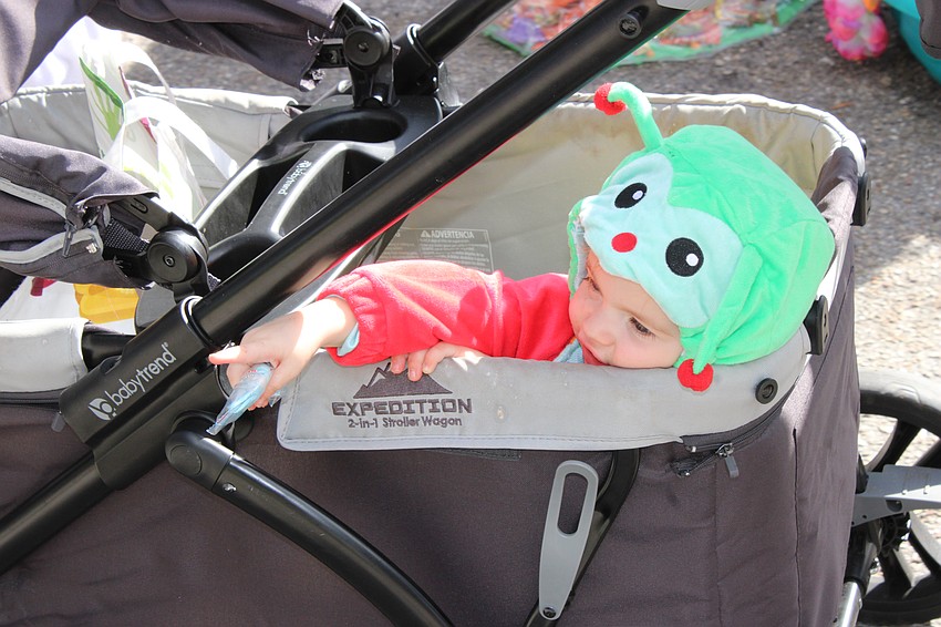 McKenzie Johnstone gets to enjoy the Kiddie Academy parade while riding the route in comfort.