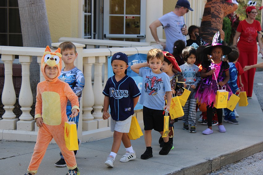 Flynn DeSoe, Anthony Marini, Nolan Koepsel, and Liam Lazek lead their class during the start of the Kiddie Academy Halloween parade.
