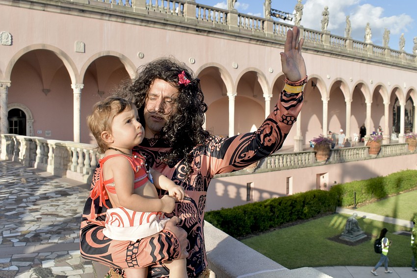 Isabella Mignogno, 1, looks at the art in the Ringling courtyard with her father Mike Mignogno.
