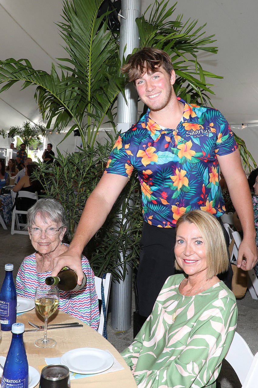 With attention to detail given to each guest, Sharky's server Jake Day keeps the wine flowing for Carole Laskowski and Danette Simons