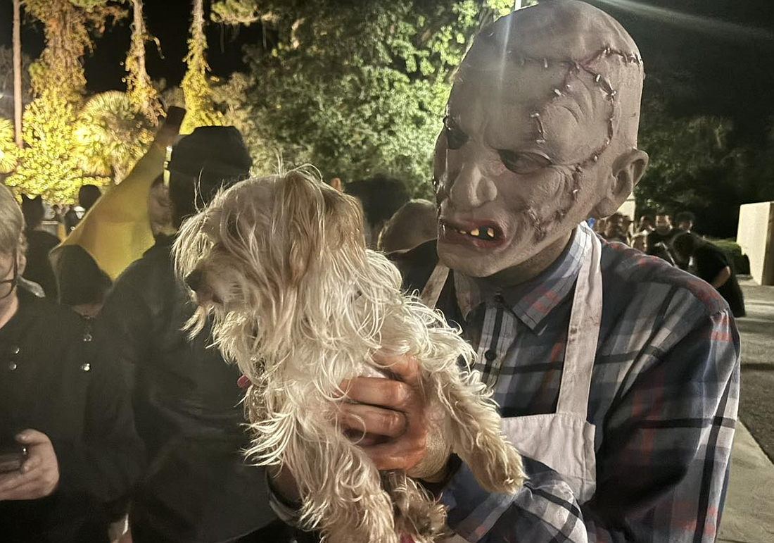 Driver Engineer Chris Cottle attempts to scare a dog in line at the Hall of Terror. Courtesy of the PCFD